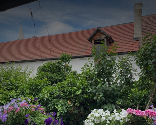 Bunte Blumen und Blätter mit einem traditionellen Gebäude und rotem Dach